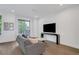 Bright living room featuring a modern sofa and a large television for entertaining guests at 230 New St # 1303, Decatur, GA 30030