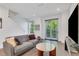 Comfortable living room with a modern couch, stylish decor, and sliding glass door to the exterior at 230 New St # 1303, Decatur, GA 30030