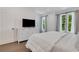 Bright main bedroom with ample closet space and a large TV for relaxing and entertainment at 230 New St # 1303, Decatur, GA 30030