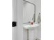 Clean and modern powder room featuring a pedestal sink, decorative mirror, and fresh design at 230 New St # 1303, Decatur, GA 30030