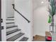 Modern staircase with dark treads, white risers, and sleek black handrail at 230 New St # 1303, Decatur, GA 30030