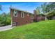 Rear of home featuring wood siding and a sloping lawn at 3492 Ember St, Marietta, GA 30066