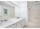 Bright bathroom with a double sink vanity, granite countertops, and a shower/tub combo with modern fixtures at 3492 Ember St, Marietta, GA 30066