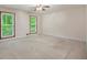 Spacious bedroom with two large windows offering natural light and tree top views, and neutral carpet at 3492 Ember St, Marietta, GA 30066