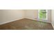 A carpeted bedroom features natural light from a window with green outdoor views at 3492 Ember St, Marietta, GA 30066