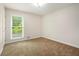 Cozy bedroom with a large window providing ample natural light and a neutral carpet at 3492 Ember St, Marietta, GA 30066