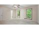 Large bedroom features two windows and ample natural light in addition to neutral carpet and ceiling fan at 3492 Ember St, Marietta, GA 30066