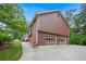 Side view of house featuring a two-car garage, walkway, and well-manicured lawn at 3492 Ember St, Marietta, GA 30066