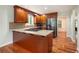 Well-lit kitchen featuring granite counters, stainless steel refrigerator, mosaic backsplash, and rich wood cabinets at 3492 Ember St, Marietta, GA 30066
