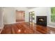 Bright living room featuring gleaming wood floors, fireplace, and sliding door access to the screened in porch at 3492 Ember St, Marietta, GA 30066