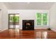 Bright living room featuring wood floors, fireplace, and sliding door access to the screened in porch at 3492 Ember St, Marietta, GA 30066