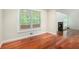 Bright sitting room featuring gleaming wood floors and a large window with a view of mature trees at 3492 Ember St, Marietta, GA 30066
