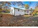 Backyard with a covered porch, mature trees, and grass at 4781 Brownsville Rd, Powder Springs, GA 30127