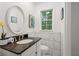 Powder room with a dark granite vanity and marble tiled walls and flooring at 4781 Brownsville Rd, Powder Springs, GA 30127