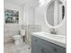 Modern bathroom with tile, blue vanity and an oval mirror at 4781 Brownsville Rd, Powder Springs, GA 30127