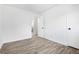 Bright bedroom with hardwood floors, and a door leading to the bathroom at 4781 Brownsville Rd, Powder Springs, GA 30127