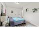 Cozy bedroom with a colorful bedspread, neutral decor, and wood-look flooring at 4781 Brownsville Rd, Powder Springs, GA 30127