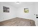This bright bedroom has a neutral color scheme, wood floors, and two large windows at 4781 Brownsville Rd, Powder Springs, GA 30127