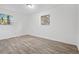 This bright bedroom has a neutral color scheme, wood floors, and two large windows at 4781 Brownsville Rd, Powder Springs, GA 30127