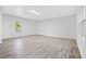 Large bonus room with new flooring, fresh paint, a large window, and access to the home's exterior at 4781 Brownsville Rd, Powder Springs, GA 30127