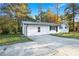 Charming single-story home with a well-maintained lawn, mature trees, and a paved driveway at 4781 Brownsville Rd, Powder Springs, GA 30127