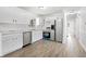 Modern kitchen with stainless steel appliances, plenty of cabinet space, and stylish stone countertops at 4781 Brownsville Rd, Powder Springs, GA 30127