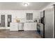 Kitchen featuring stainless steel appliances, bright white cabinets, and neutral countertops at 4781 Brownsville Rd, Powder Springs, GA 30127