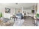 Spacious living room featuring a blue sofa, gray chairs, modern art, and stylish decor at 4781 Brownsville Rd, Powder Springs, GA 30127