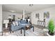 Open-concept living room flowing into a kitchen with white cabinets and stainless steel appliances at 4781 Brownsville Rd, Powder Springs, GA 30127