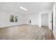 Bright living space featuring new flooring, fresh paint, and an adjoining door to the rest of the home at 4781 Brownsville Rd, Powder Springs, GA 30127