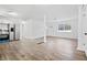 Open living space featuring new flooring, fresh paint, and an updated kitchen view with stainless appliances at 4781 Brownsville Rd, Powder Springs, GA 30127