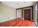 This is a bedroom with hardwood floors, earth tone colored walls, and a closet with bi-fold doors at 6134 Silver Spur Dr, Lithonia, GA 30058