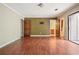 A large bedroom with wood floors and doorways to the bathroom and outside at 6134 Silver Spur Dr, Lithonia, GA 30058