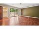 Spacious primary bedroom with wood floors and a sliding glass door at 6134 Silver Spur Dr, Lithonia, GA 30058