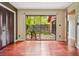 This bedroom has hardwood floors, neutral colored walls, and a view through sliding glass doors to a courtyard at 6134 Silver Spur Dr, Lithonia, GA 30058