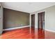 Bedroom featuring shiny hardwood floors, closet with bi-fold doors, and walls painted in neutral earth tones at 6134 Silver Spur Dr, Lithonia, GA 30058