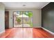 Neutral colored bedroom with hardwood floors and a view of courtyard through sliding glass doors at 6134 Silver Spur Dr, Lithonia, GA 30058