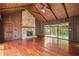 Living room boasts vaulted wood ceilings, a stone fireplace, and large windows at 6134 Silver Spur Dr, Lithonia, GA 30058