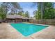 Enjoy the backyard pool, with a diving board and chain-link fence surrounding the yard at 6134 Silver Spur Dr, Lithonia, GA 30058