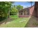 The large screened-in porch overlooks the grassy backyard at 6134 Silver Spur Dr, Lithonia, GA 30058