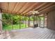 Screened porch featuring ceiling fan, wooden deck, and view to yard and pool at 6134 Silver Spur Dr, Lithonia, GA 30058