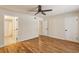 Spacious bedroom featuring hardwood floors, a ceiling fan, and ensuite bathroom access at 104 Verlaine Nw Pl, Atlanta, GA 30327