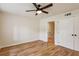 Minimal bedroom featuring hardwood floors, a ceiling fan, and closet space at 104 Verlaine Nw Pl, Atlanta, GA 30327