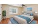 Well-lit primary bedroom features hardwood floors, ceiling fan and large window at 104 Verlaine Nw Pl, Atlanta, GA 30327