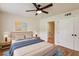 Bright bedroom with a comfortable bed, wooden floors, and a ceiling fan at 104 Verlaine Nw Pl, Atlanta, GA 30327