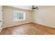 Bedroom featuring hardwood floors and large window at 104 Verlaine Nw Pl, Atlanta, GA 30327