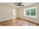 Bedroom featuring hardwood floors, a ceiling fan, and a bathroom and window at 104 Verlaine Nw Pl, Atlanta, GA 30327