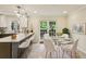 Modern eat-in kitchen with updated lighting, sleek appliances, and a stylish dining table at 104 Verlaine Nw Pl, Atlanta, GA 30327
