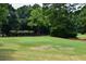 Scenic putting green on a golf course lined with flowering bushes, highlighting a verdant landscape at 104 Verlaine Nw Pl, Atlanta, GA 30327