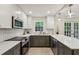 Bright, updated kitchen with modern stainless steel appliances, white and gray cabinets, and quartz countertops at 104 Verlaine Nw Pl, Atlanta, GA 30327